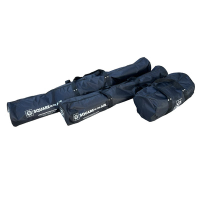 Three black duffle bags lying next to each other on a white background. 