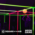 Fun game that glows under blacklight. Indoor Use. Student playing 9 Square in the Air with a glowing NEON  orange ball and pink and yellow game set.