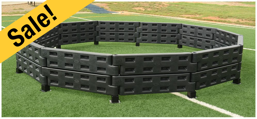 Black gagaball pit on an outdoor green athletic field 